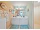 Bathroom with a double sink vanity and a walk in shower at 458 Grant St, Dunedin, FL 34698