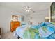 A lovely bedroom featuring neutral carpet, ceiling fan, double door closet and natural light at 458 Grant St, Dunedin, FL 34698