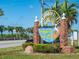 Dunedin Causeway sign welcomes visitors with brick columns, palms and a glimpse of the road beyond at 458 Grant St, Dunedin, FL 34698
