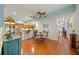 Open floor plan featuring a dining area, kitchen with bar seating, hardwood floors, ceiling fans and natural light at 458 Grant St, Dunedin, FL 34698