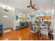 Cozy dining area with hardwood floors, stylish decor, and a view of the modern kitchen at 458 Grant St, Dunedin, FL 34698