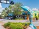 Lively downtown street featuring a decorative dolphin sculpture, colorful storefronts, and palm trees at 458 Grant St, Dunedin, FL 34698