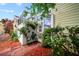 Charming, screened-in outdoor area with lush landscaping and a welcoming entrance at 458 Grant St, Dunedin, FL 34698