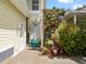Welcoming entrance featuring a cozy porch, vibrant plants, and a private driveway at 458 Grant St, Dunedin, FL 34698