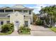 Charming yellow townhome featuring a well-manicured front yard and private driveway at 458 Grant St, Dunedin, FL 34698