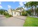 Well-maintained home with a private drive, a covered balcony, and tropical landscaping at 458 Grant St, Dunedin, FL 34698