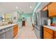 Bright kitchen showcasing stainless steel appliances, tile flooring and a small office area at 458 Grant St, Dunedin, FL 34698