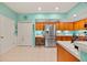 Bright, spacious kitchen with stainless steel refrigerator, ample cabinet space, and a tile floor at 458 Grant St, Dunedin, FL 34698