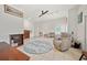 Bright living room with white walls, tile flooring, ceiling fan, and chair at 458 Grant St, Dunedin, FL 34698
