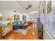 Living room with high ceilings, wood floors, comfortable seating, and an open floor plan at 458 Grant St, Dunedin, FL 34698