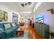 Spacious living room featuring high ceilings, wood floors, comfortable seating, and access to the screened lanai at 458 Grant St, Dunedin, FL 34698