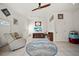 Bright living room with white walls, tile flooring, and entertainment center with TV at 458 Grant St, Dunedin, FL 34698