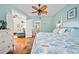Bright main bedroom with a ceiling fan and coastal-themed decor at 458 Grant St, Dunedin, FL 34698