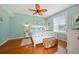 Cozy main bedroom with warm wood floors and natural light from the window at 458 Grant St, Dunedin, FL 34698