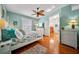Comfortable bedroom featuring hardwood floors, neutral paint, and a ceiling fan at 458 Grant St, Dunedin, FL 34698