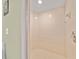 Bathroom shower with light tile and new shower head at 458 Grant St, Dunedin, FL 34698