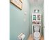 Bathroom toilet room with a cabinet for storage and coastal decor at 458 Grant St, Dunedin, FL 34698