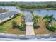 Beautiful home with brick driveway, lush landscaping, and views of a lake at 1950 Sterling Glen Ct, Sun City Center, FL 33573