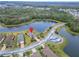 An aerial shot highlights the home's location near a tranquil lake in a well-maintained community at 1950 Sterling Glen Ct, Sun City Center, FL 33573