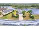 Lovely home with brick driveway, tropical landscaping, and water views at 1950 Sterling Glen Ct, Sun City Center, FL 33573