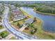 Beautiful home with a brick driveway, lush landscaping, and amazing lake views at 1950 Sterling Glen Ct, Sun City Center, FL 33573