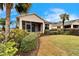 The backyard shows greenery and the rear of the house at 1950 Sterling Glen Ct, Sun City Center, FL 33573