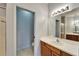 Bright bathroom featuring a vanity with a sink, mirror, and doorway to a separate toilet room at 1950 Sterling Glen Ct, Sun City Center, FL 33573