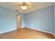 Bright bedroom featuring laminate flooring, ceiling fan, and ample closet space at 1950 Sterling Glen Ct, Sun City Center, FL 33573