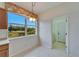 Bright breakfast nook with tile flooring and a large window offering a view of the front yard at 1950 Sterling Glen Ct, Sun City Center, FL 33573