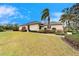 The exterior showcases a well-maintained lawn, manicured shrubs, and a charming walkway at 1950 Sterling Glen Ct, Sun City Center, FL 33573