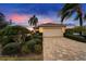 The exterior of the home features a well-manicured yard, driveway, and a spacious two-car garage at 1950 Sterling Glen Ct, Sun City Center, FL 33573