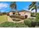 A beautiful home with a well-kept lawn, trimmed hedges, and a convenient two-car garage at 1950 Sterling Glen Ct, Sun City Center, FL 33573