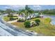 Beautiful home with a brick driveway, lush landscaping, and water views at 1950 Sterling Glen Ct, Sun City Center, FL 33573