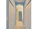 Hallway with tile flooring and archway, connecting to the bathroom, with multiple closet spaces at 1950 Sterling Glen Ct, Sun City Center, FL 33573