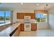 Well-lit kitchen featuring ample counter space, modern appliances, and natural light from the windows at 1950 Sterling Glen Ct, Sun City Center, FL 33573