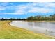 Scenic lake view with lush green surroundings offering a serene and peaceful environment at 1950 Sterling Glen Ct, Sun City Center, FL 33573