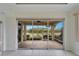 View of the screened lanai and lake from the living room featuring tile flooring at 1950 Sterling Glen Ct, Sun City Center, FL 33573