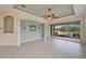 Open living room with tile floors and access to an outdoor patio at 1950 Sterling Glen Ct, Sun City Center, FL 33573