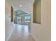 Bright living room featuring tiled floors, tray ceiling, and ample natural light from windows and recessed shelving at 1950 Sterling Glen Ct, Sun City Center, FL 33573