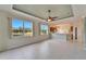Open living room features tile floors and multiple windows at 1950 Sterling Glen Ct, Sun City Center, FL 33573