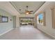 Bright living area with tile flooring, ceiling fan, lake view, and screened in lanai access at 1950 Sterling Glen Ct, Sun City Center, FL 33573