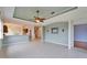 Open floor plan living area with tile flooring, ceiling fan, and easy access to the kitchen at 1950 Sterling Glen Ct, Sun City Center, FL 33573