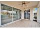 Screened-in patio with tile floor and sliding glass doors, leading to the bright kitchen at 1950 Sterling Glen Ct, Sun City Center, FL 33573