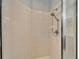 Tile shower featuring a shower head, soap dish, and metal handle and door at 1950 Sterling Glen Ct, Sun City Center, FL 33573