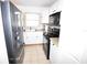 A bright kitchen featuring white cabinets, a black appliance suite, and granite countertops at 207 S Mcmullen Booth Rd # 198, Clearwater, FL 33759