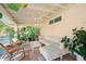 Cozy covered patio featuring comfortable lounge furniture, tropical plants, and inviting decor at 4056 18Th S Ave, St Petersburg, FL 33711
