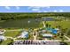 Aerial view of a community splash park and playground area next to a scenic lake at 4154 Pinelake Ln # 101, Tampa, FL 33618