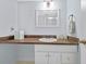 Bright bathroom features a sink vanity with wood countertop, neutral paint and decoratives at 4154 Pinelake Ln # 101, Tampa, FL 33618