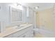 Bathroom with modern sink vanity, large mirror, and bathtub with shower at 4154 Pinelake Ln # 101, Tampa, FL 33618