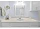 Bright bathroom with modern sink vanity, large mirror, neutral paint and decoratives at 4154 Pinelake Ln # 101, Tampa, FL 33618